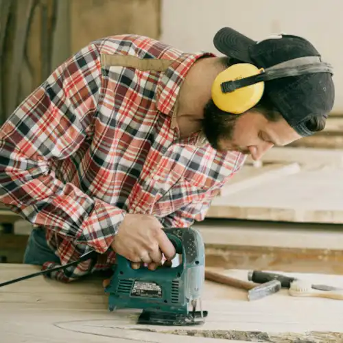 Certified Aging-in-Place Specialist sawing during a remodel