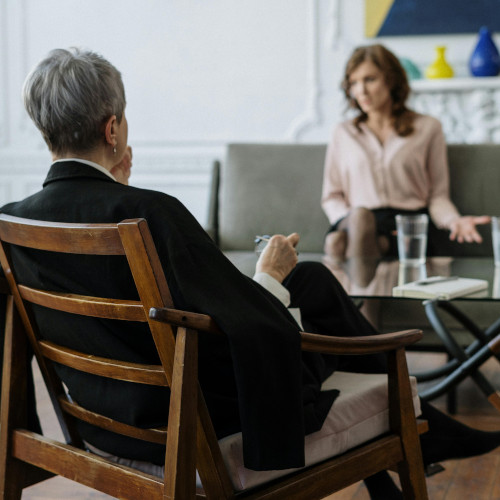 a doctor talking to a patient while seated