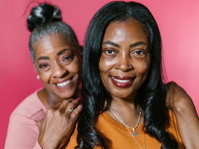 And elderly woman and her mother smiling at the camera